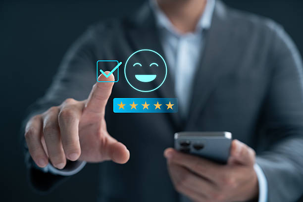istock Customer satisfaction survey via online application, customers use smartphones to express their feedback with emoticons ranging from happy to sad, providing the best service and product quality. 2213292580