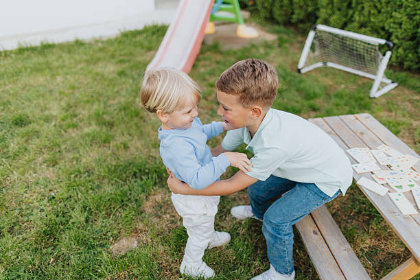 istock Brothers enjoying leisure games in backyard 2213292930