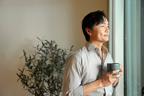 istock Breakfast man scrolling cellphone drinking coffee at home 2213296808