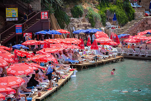August 04, 2024 Turkiye Antalya Kaleici public beach.A group of tourists on a Turkish beach.