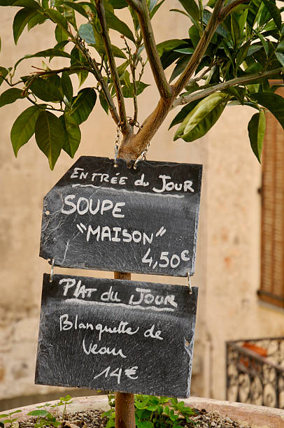 Marseille, France, 05 30 2025 : man handing a lighter to café customer on outdoor terrace, solidarity, real urban scene, Marseille, France