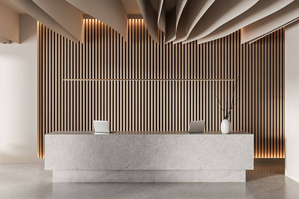 istock Modern minimalist reception desk with laptops and decorative ceiling panels in contemporary office lobby interior design setting. 3D Rendering 2213299908