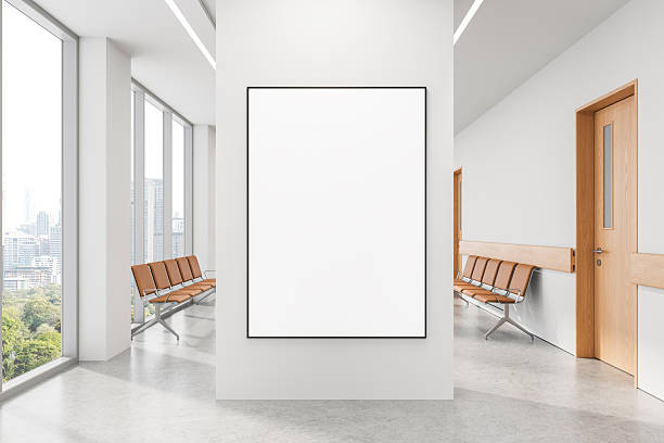 istock Vertical blank poster mockup on white wall in modern waiting room with bright interior and city view through large windows in clean design layout. 3D Rendering 2213299963