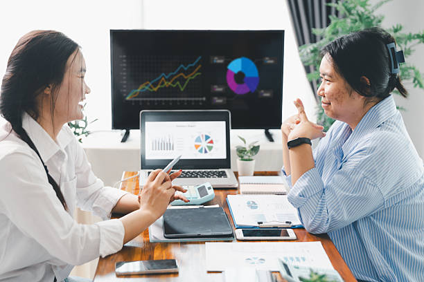 istock People meeting using laptop computer, calculator, stock market chart paper for analysis plans to improve quality. Team working on project. Analysis business brainstorming corporate smart Concept. 2213300973