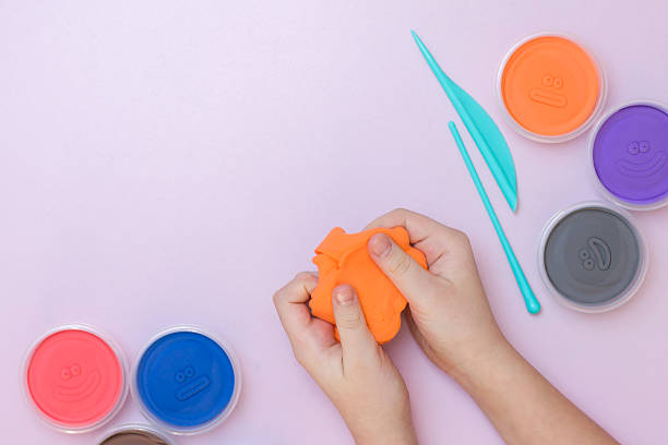 istock A child holds soft plasticine.  Multicolored plasticine. 2213302835