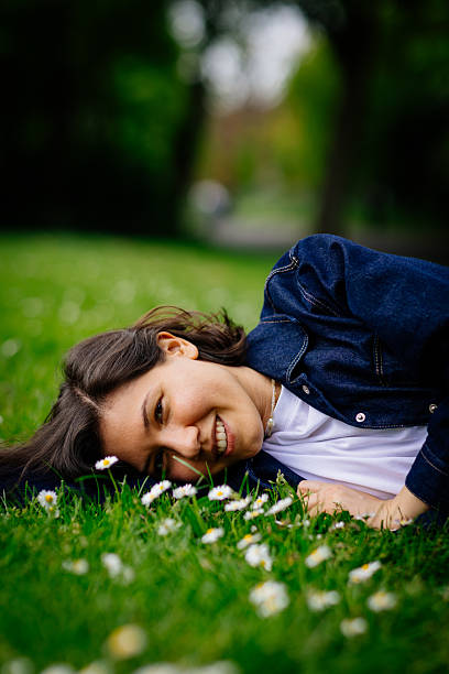Beautiful woman relaxing on a grass