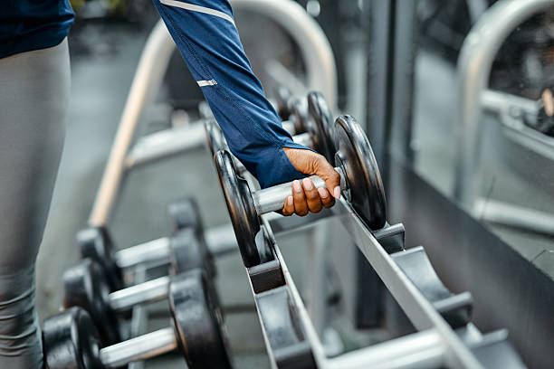 istock Athlete picking up dumbbell in a modern gym 2213307251