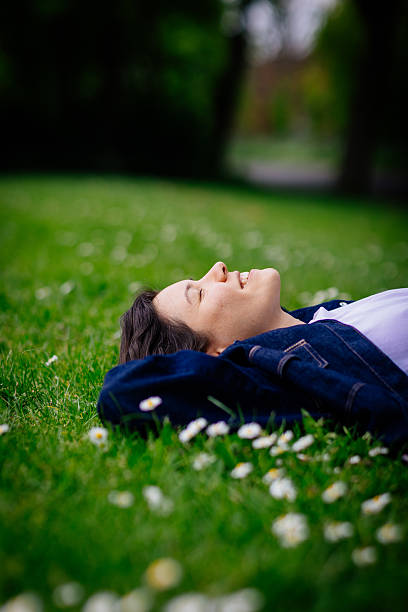 istock Beautiful woman relaxing on a grass 2213307262