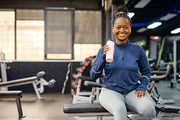 istock Young woman drinking protein shake after training in the gym 2213307267