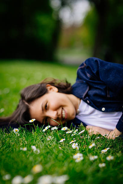 istock Beautiful woman relaxing on a grass 2213307275