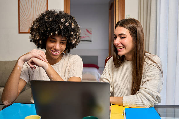 istock Two female students collaborating on a project, studying together on laptop 2213309237