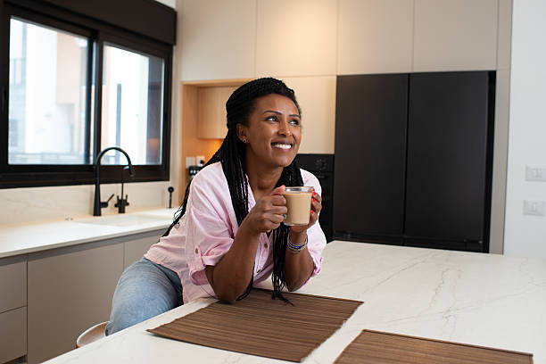 istock Relaxed Woman Enjoying Coffee in Modern Kitchen. 2213309542