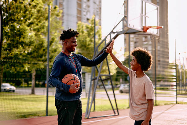 istock Basketball coach and player giving high five after training 2213309581