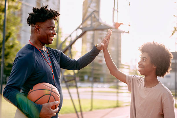 istock Basketball coach and player giving high five after training 2213309788