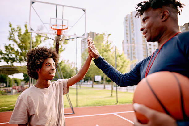 istock Basketball coach and player giving high five after training 2213309920