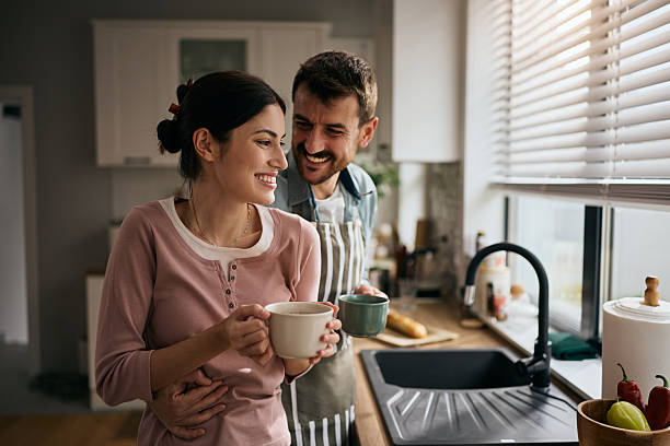 istock Happy couple having fun while drinking coffee in the kitchen. 2213312370