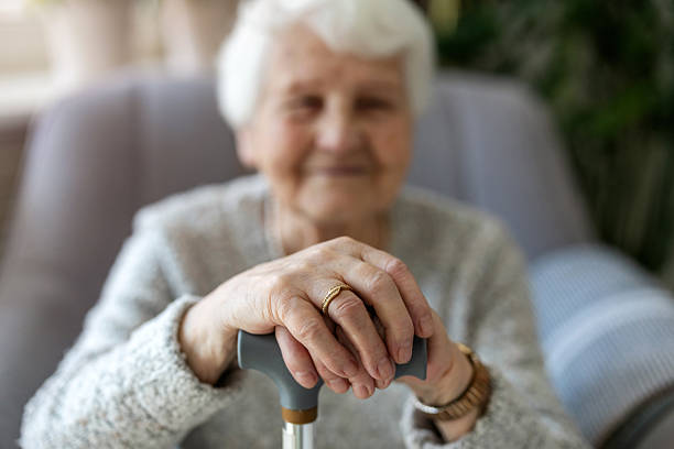 istock Elderly woman resting her hands on a cane 2213315646