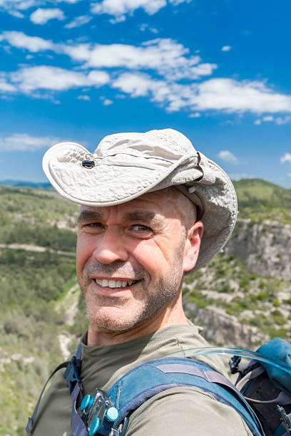 istock Happy man takes a selfie outdoors on a hiking journey 2213316417