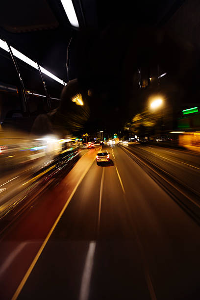 A dynamic night scene showcasing a fast-moving car on Sydney's city streets under vibrant streetlights