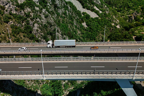 istock Cargo Truck Driving on Elevated Mountain Highway 2213317172