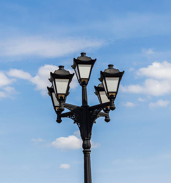 istock Vintage, cast iron street lamp post with cloudy background. Concept 2213318444