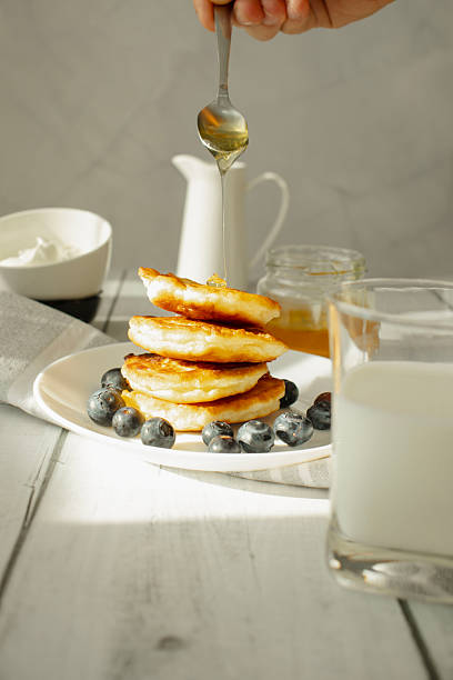 istock Pancakes with berries and honey. on the table. breakfast 2213319330