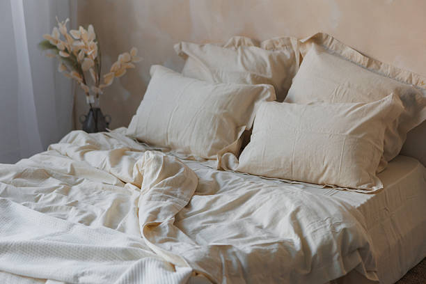 istock A cozy bedroom with a comfortable bed, white sheets, and fluffy pillows 2213319733