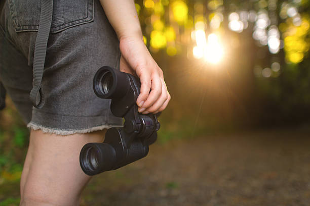 istock Young woman with binoculars travelling in nature, bird watching 2213320662
