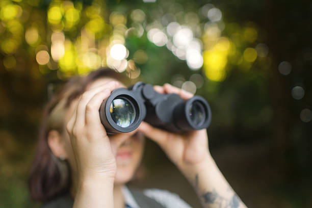 istock Young woman with binoculars travelling in nature, bird watching 2213320726