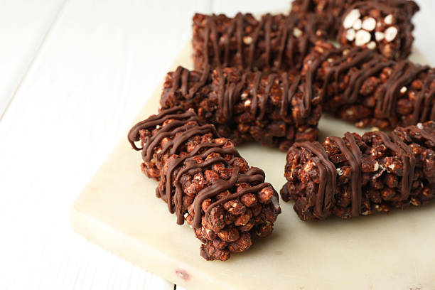 istock Delicious chocolate puffed rice bars on white wooden table, closeup. Space for text 2213323224