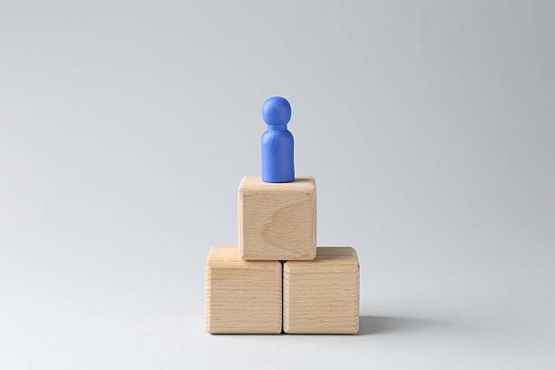 istock Competition concept. Human figure on wooden cubes against light background 2213323263