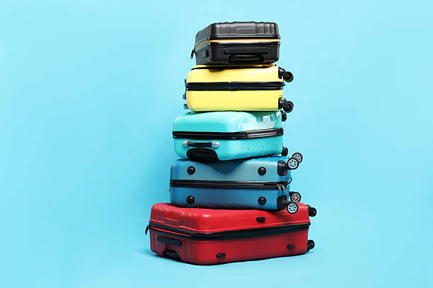 istock Stack of colorful suitcases on light blue background 2213323777