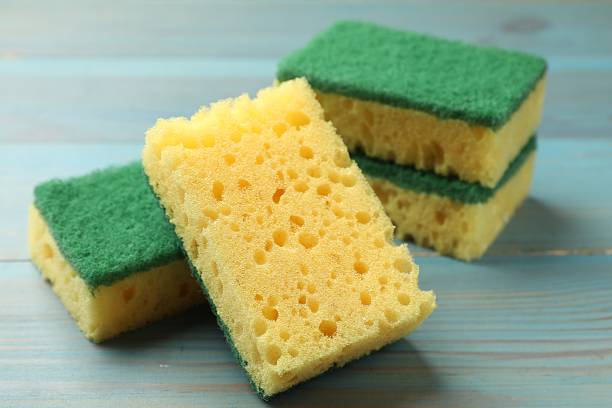 istock Soft sponges on light blue wooden table, closeup 2213323856