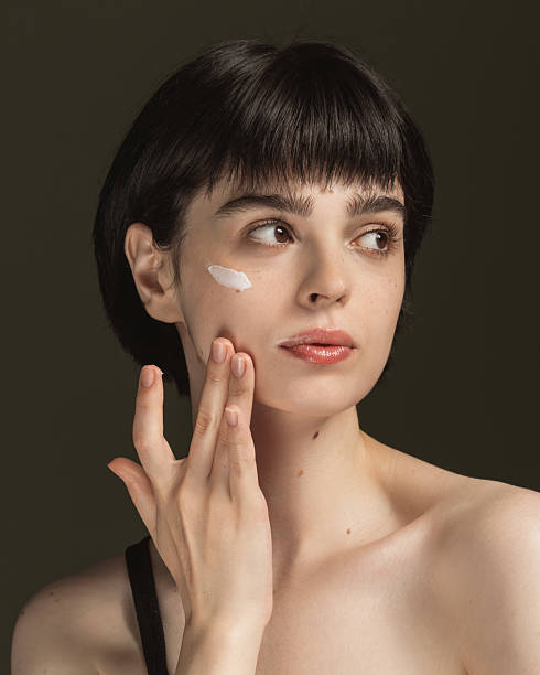 istock Cream on face. Skin moisturizing 2213326692