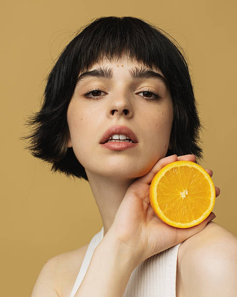 istock Young woman with orange 2213326740