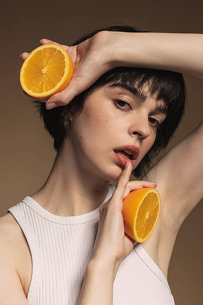 istock Young woman with orange 2213326774