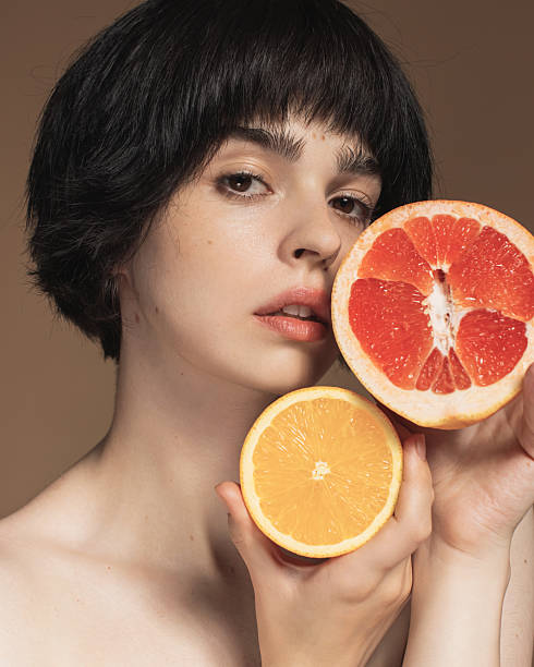 istock Young woman with grapefruit 2213326856