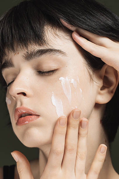 istock Cream on face. Skin moisturizing 2213326895