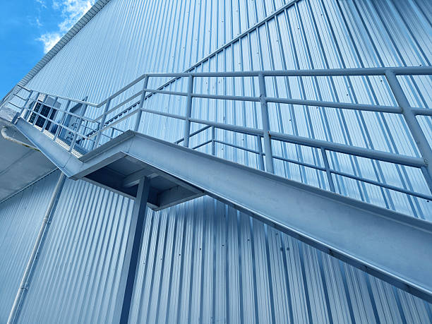 istock A set of stairs ascending a large blue wall 2213328568