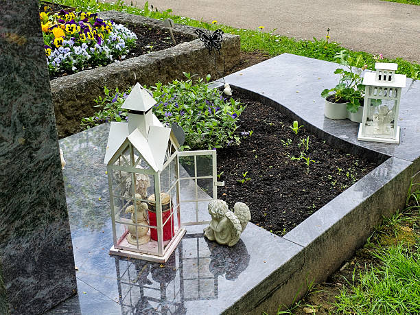 istock Grave with lanterns and angel statue on polished granite 2213328705