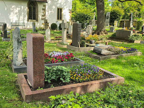 istock Grave decorated with colorful pansies and granite border. 2213328887