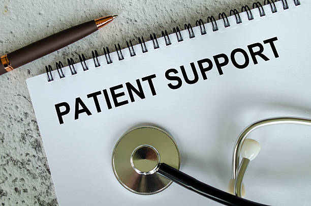 istock Top view of Patient Support text on white paper notepad with stethoscope on wooden table background. Health and medical concept. 2213331834