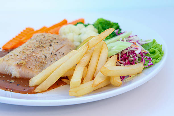 Crispy roasted chicken served with golden seasoned potato wedges and vibrant cherry tomatoes. Fresh spinach adds color to this appetizing meal, perfect for lunch or dinner.