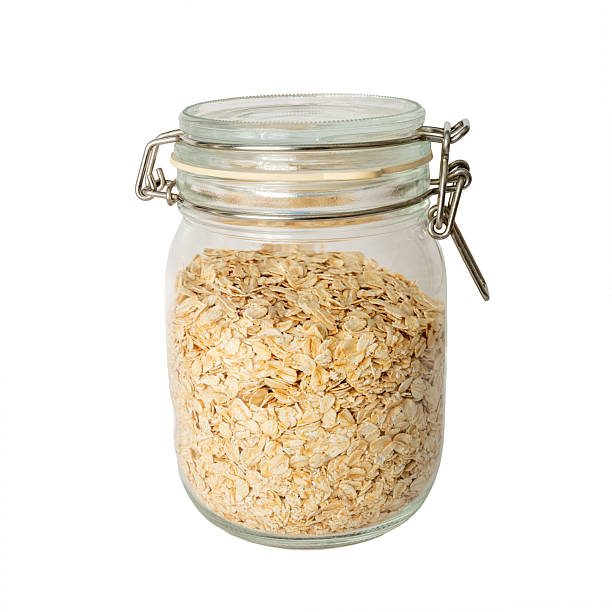 istock The dried oat rice in glass bottle isolate background 2213342968