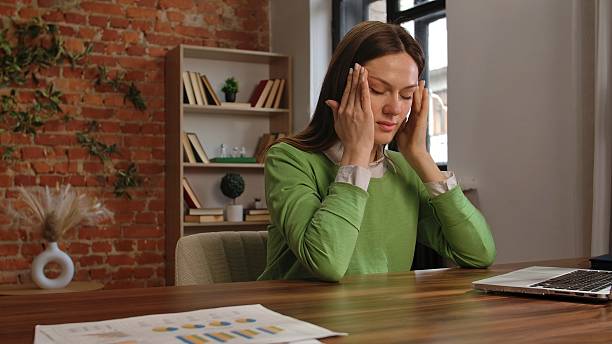 istock Stressed Woman Sitting at Desk in Modern Office Environment 2213345041