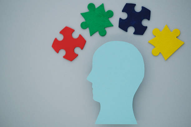 istock Silhouette of a blue head with colorful puzzle 2213348082