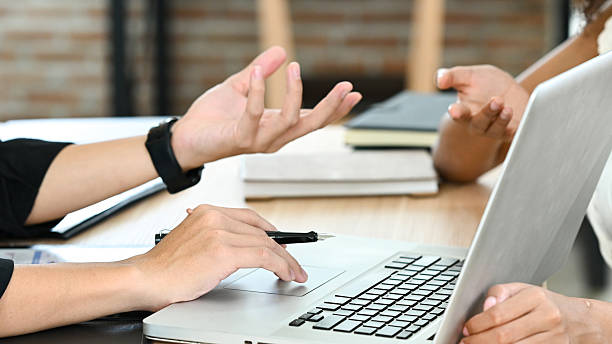 istock A person is typing on a keyboard at a desk with a book and a cup. 2213349931