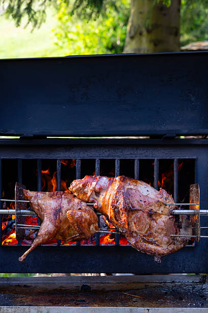 istock Roasting pork and turkey on spit 2213350992