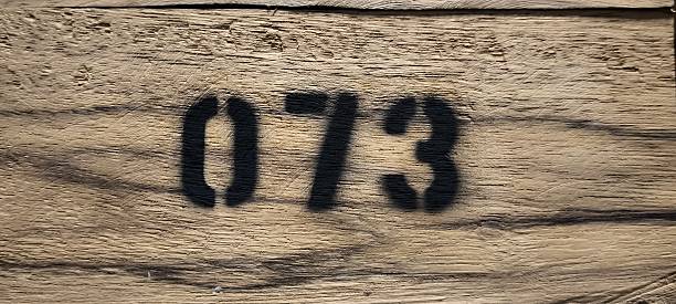 istock The number 073 is spray painted with black spray paint on wood 2213354549