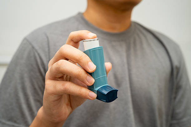istock Asthma and chronic obstructive pulmonary disease COPD, Asian young man using metered dose inhaler MDI. 2213359227
